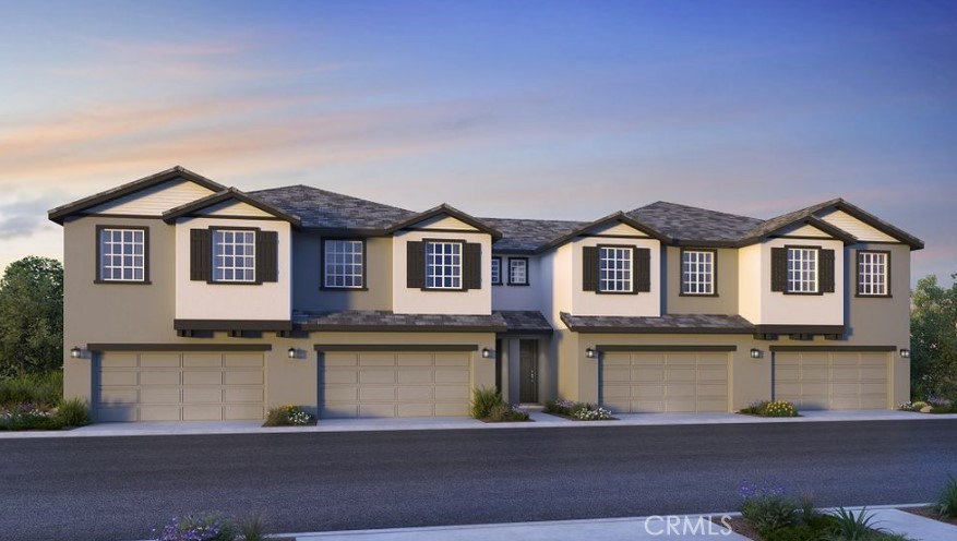 a front view of a house with yard and parking