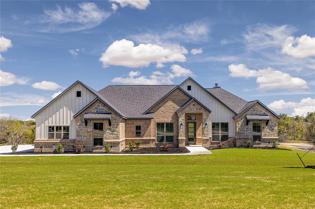 a front view of a house with swimming pool having outdoor seating