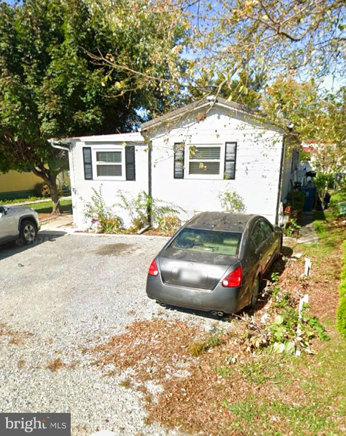 a view of a white house with a yard