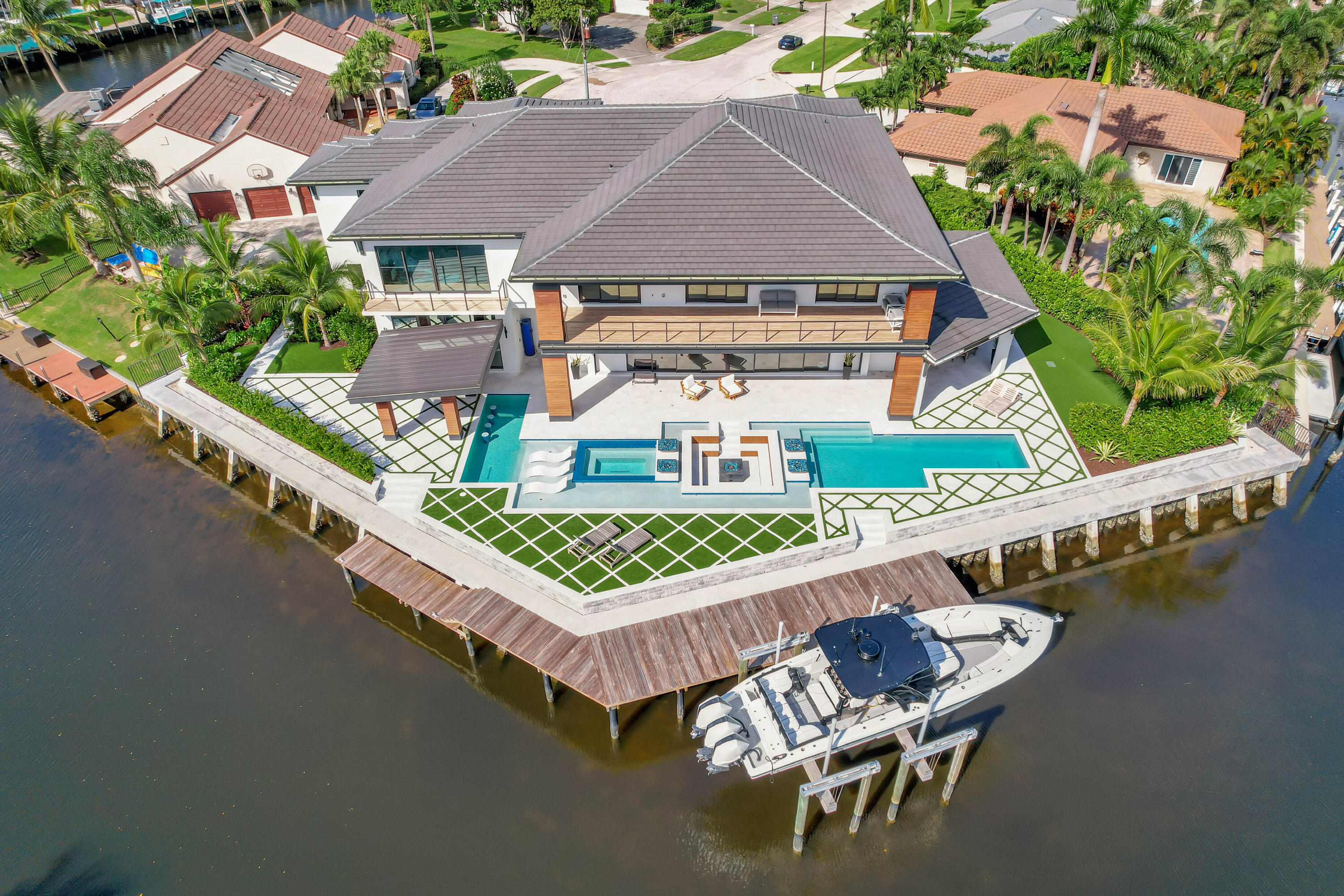 an aerial view of a house with swimming pool patio and outdoor seating