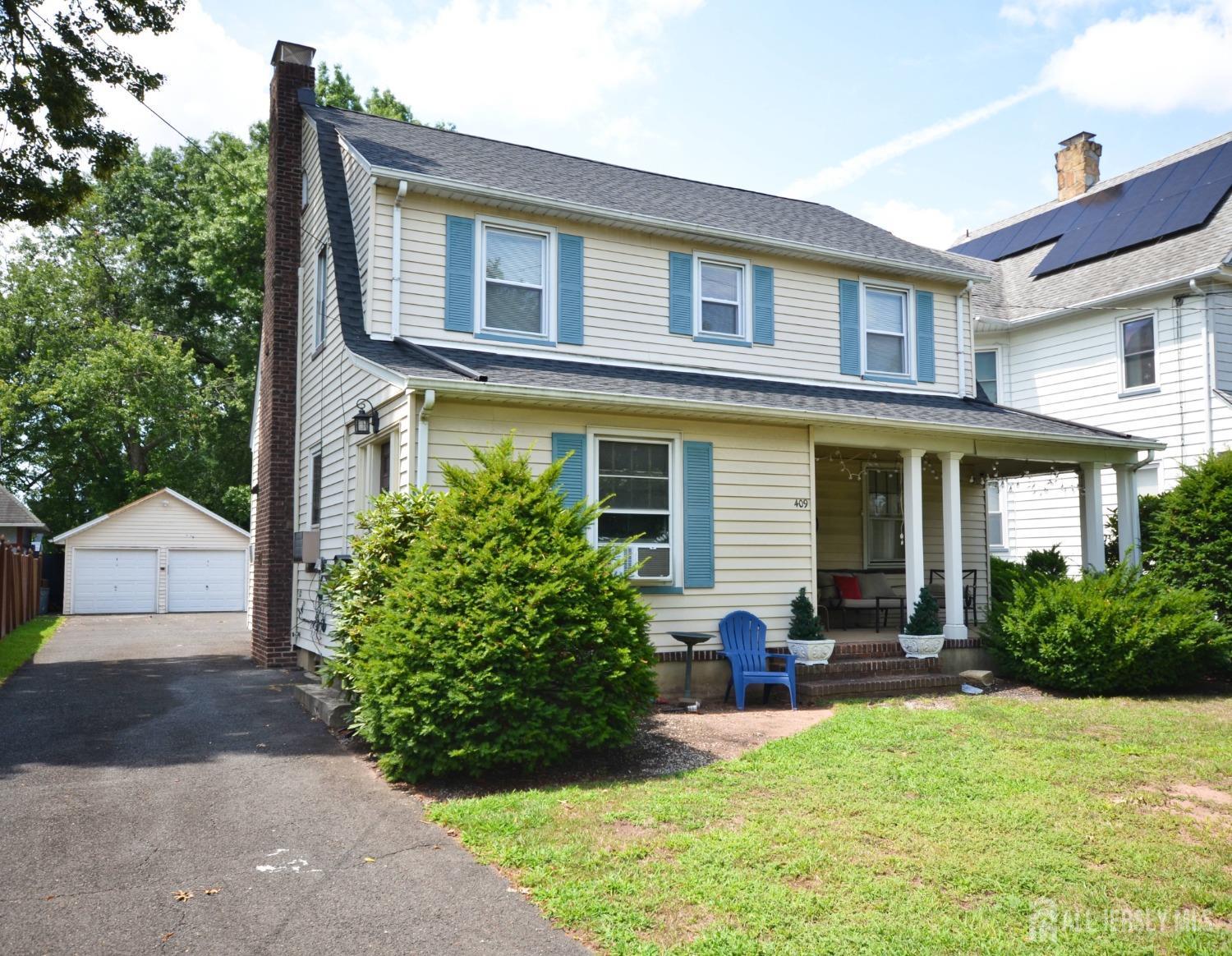 a front view of a house with yard and green space