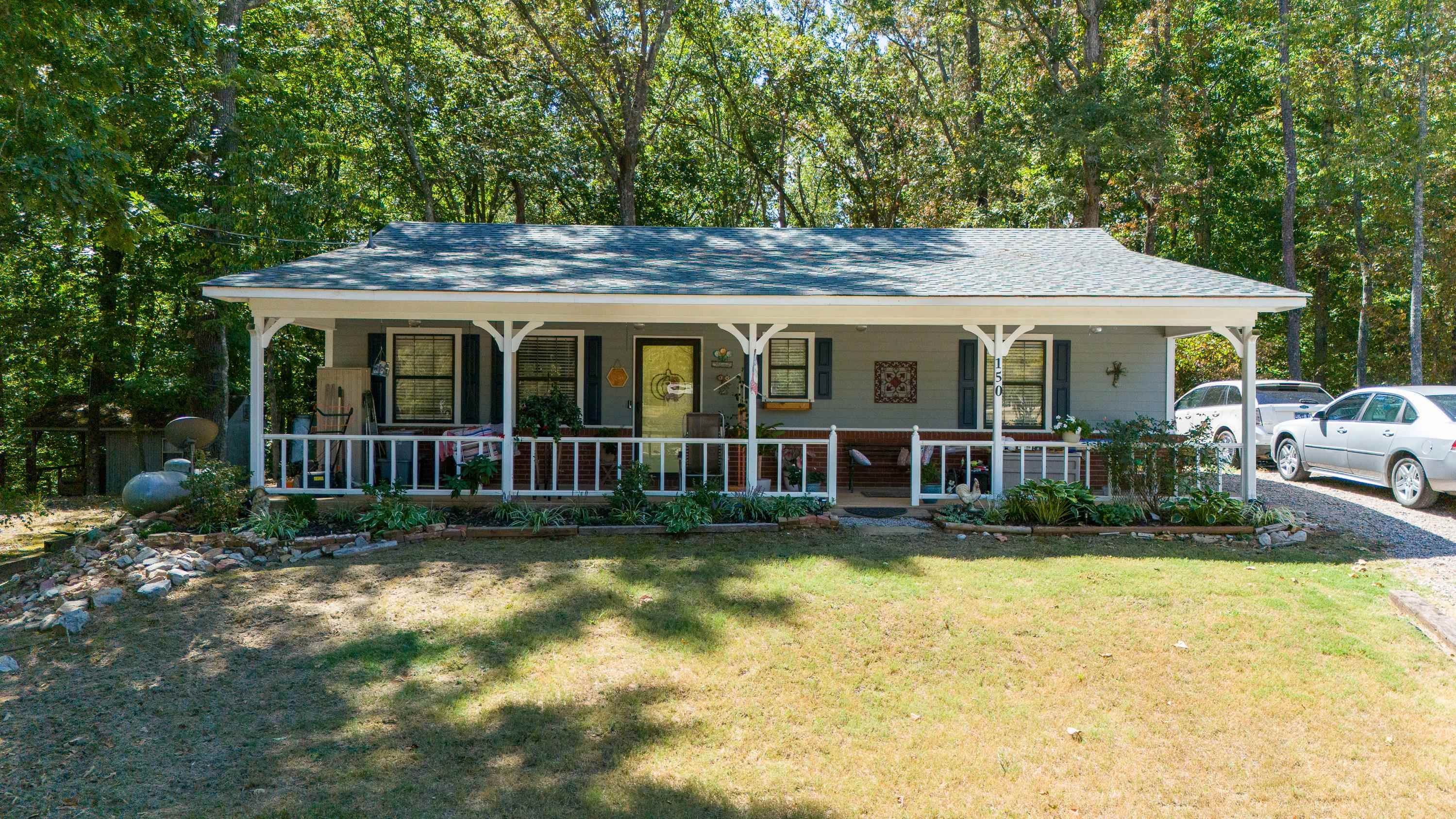 a view of a house with swimming pool and porch