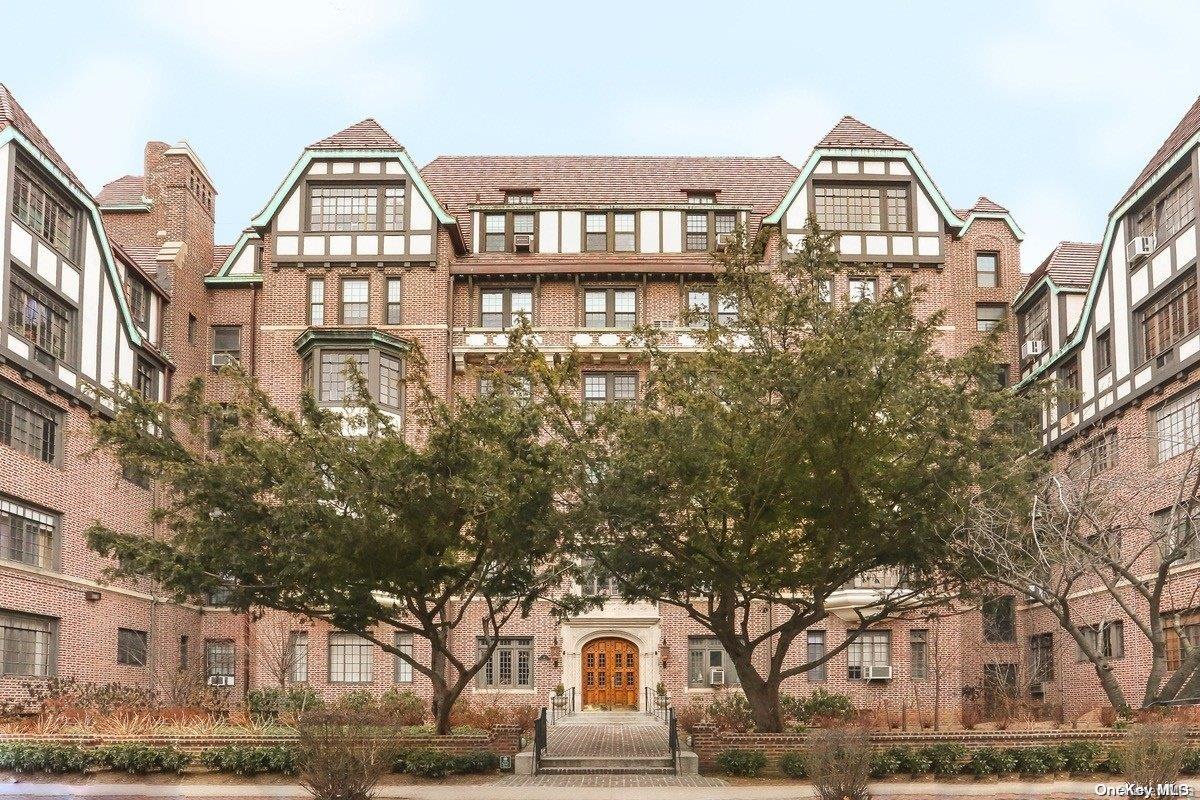 a front view of a residential apartment building with a yard