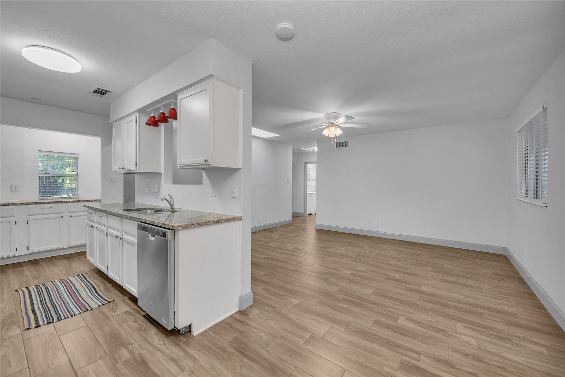 a kitchen with granite countertop a stove and a sink