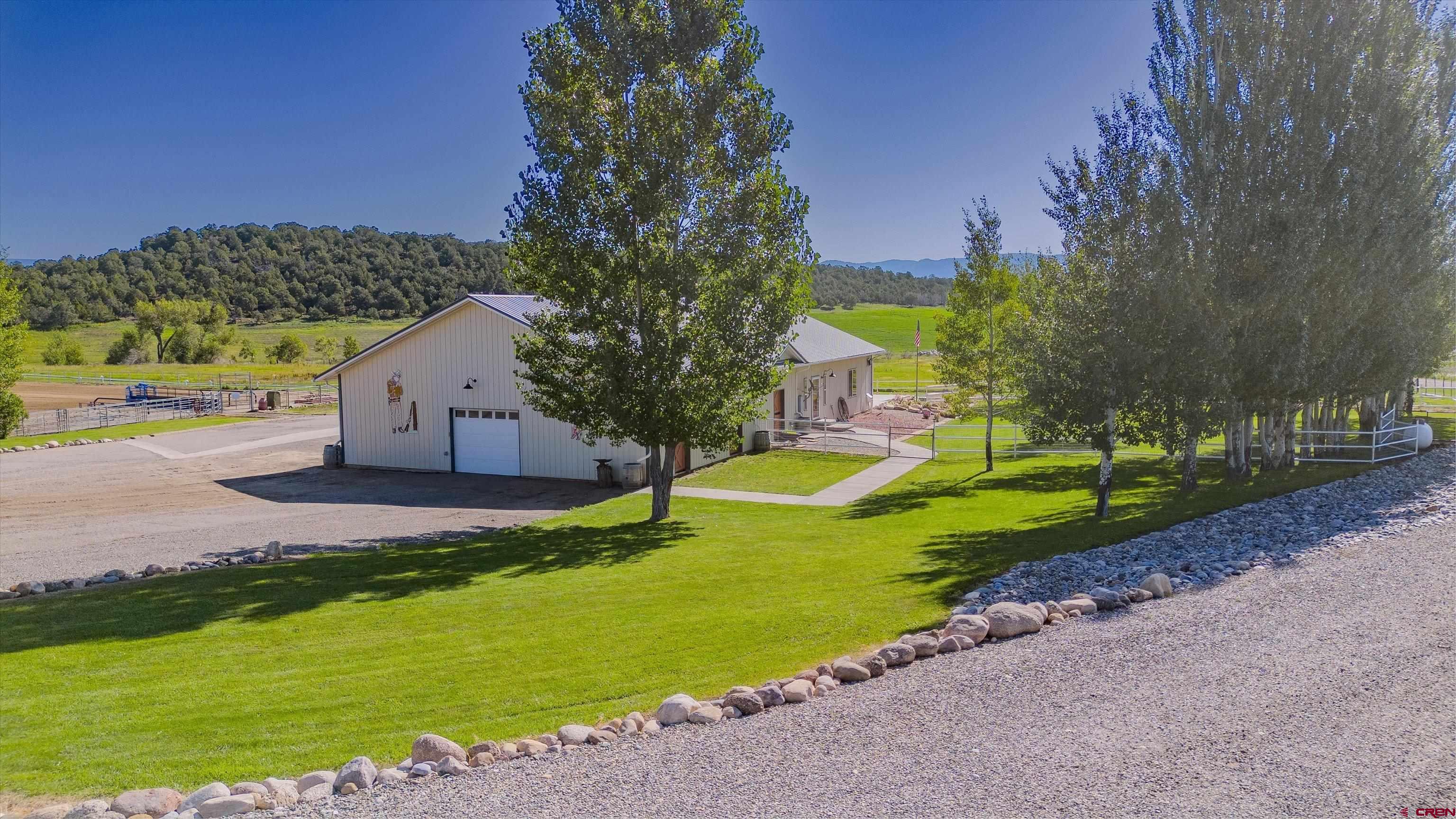 a view of a house with swimming pool and a yard