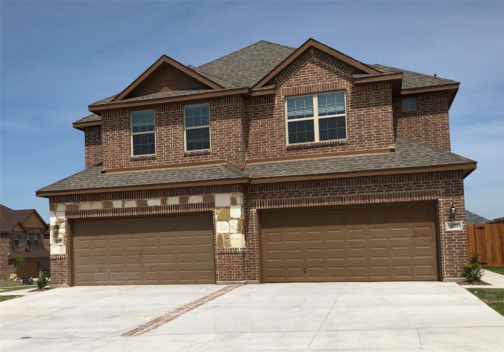 a front view of a house with garage