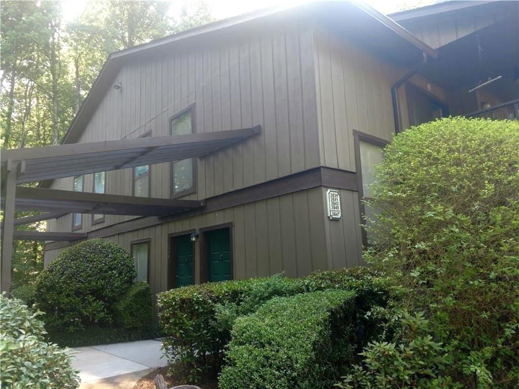 a front view of a house with plants