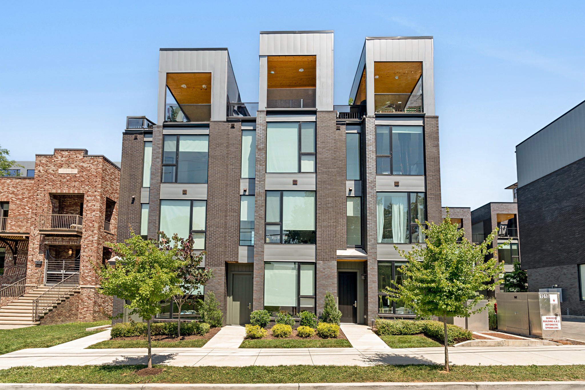 a front view of a residential apartment building with a yard