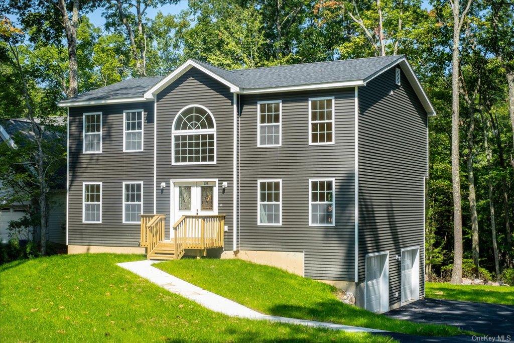 a front view of a house with a yard