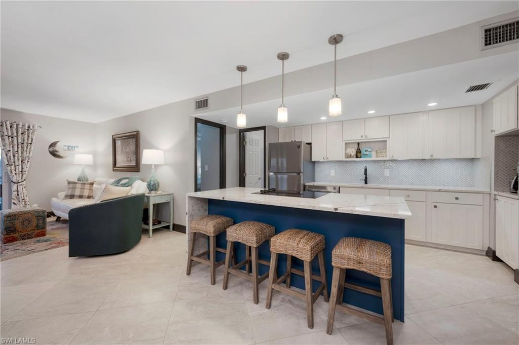 a large kitchen with a table and chairs in it