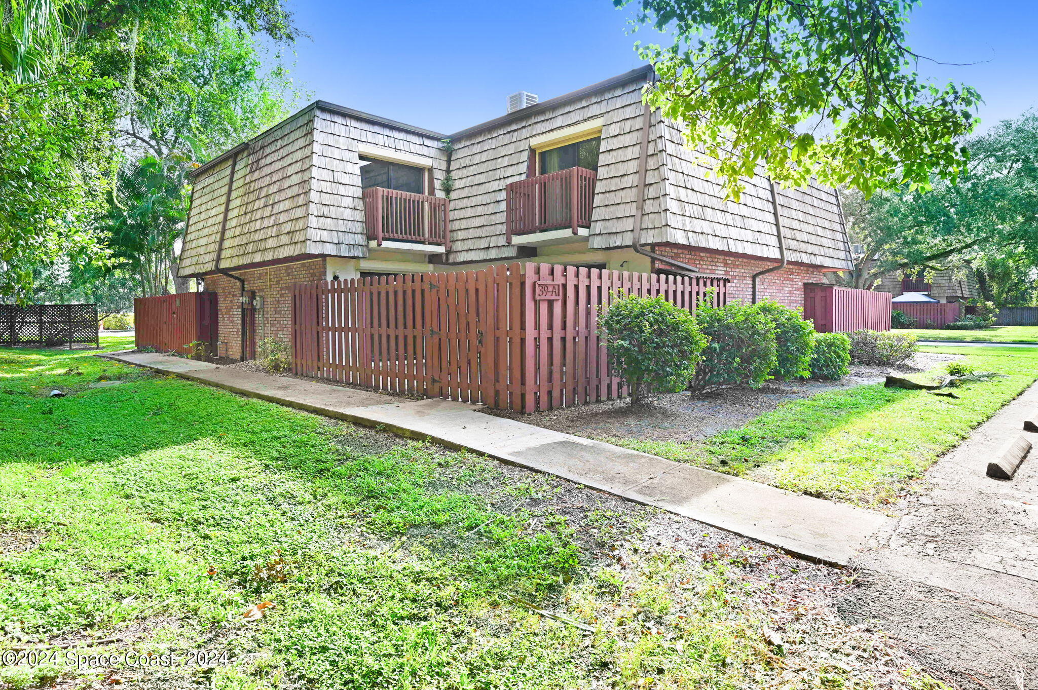 a front view of a house with yard and green space