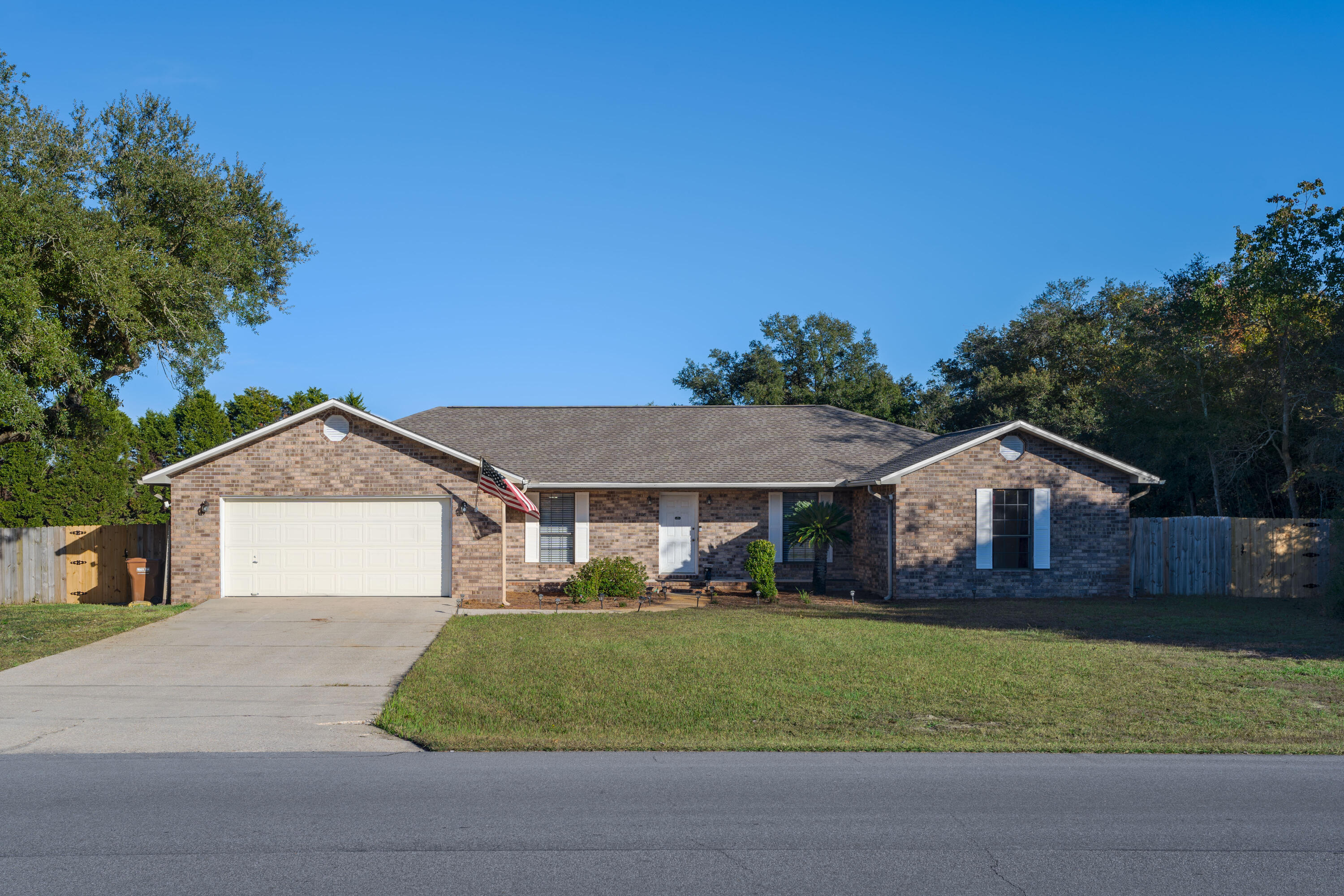 a front view of a house with a garden and yard