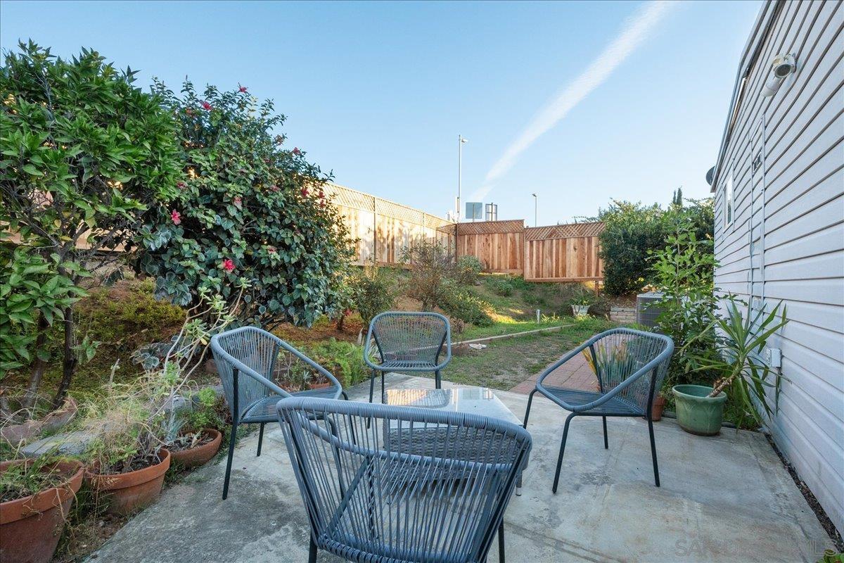 a view of a chair and table in backyard