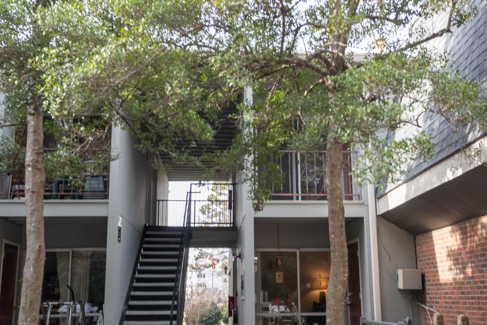 a front view of a house with a tree