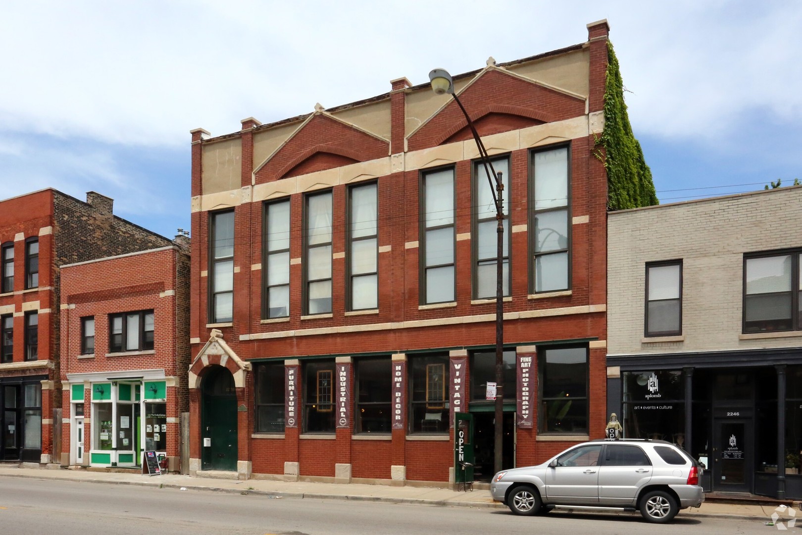 front view of a street that has couple of cars parked in front of it