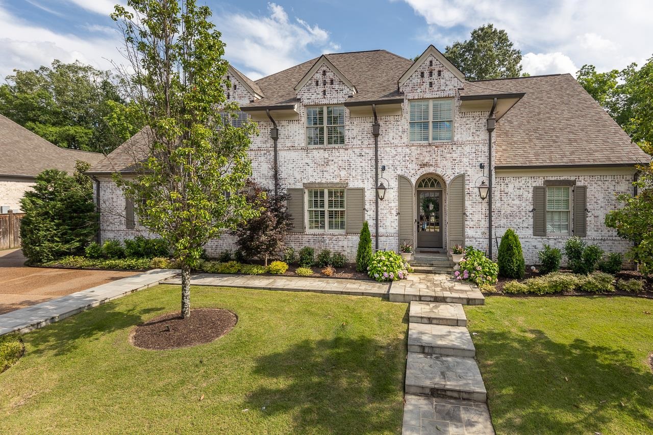 a front view of a house with a yard