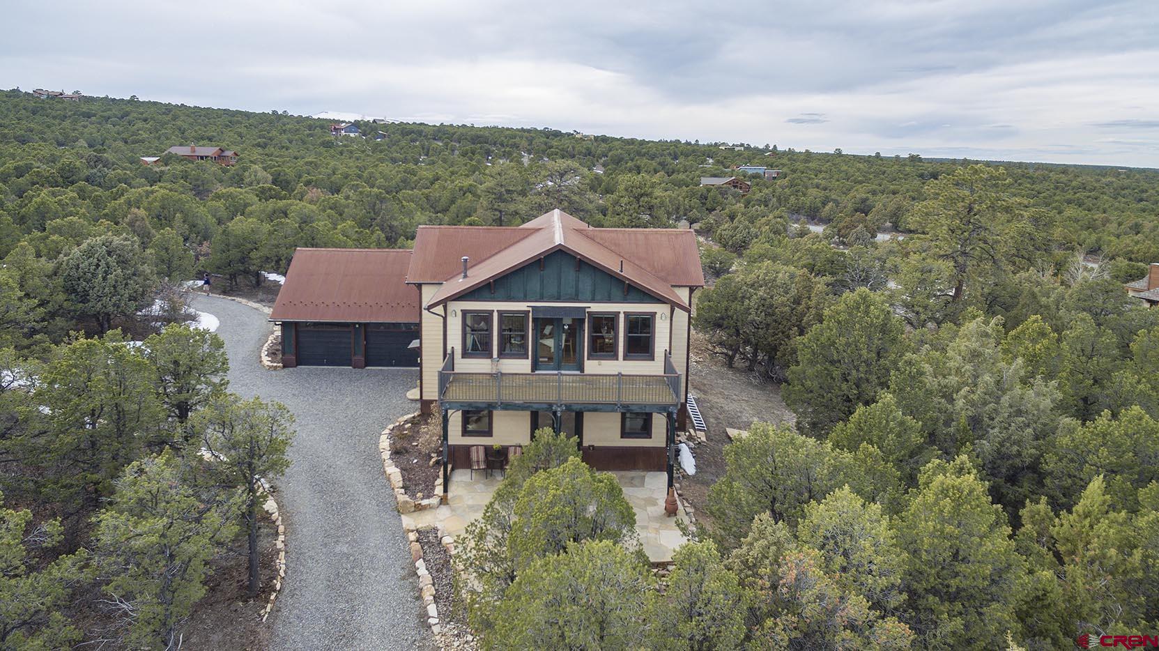 an aerial view of a house with a big yard