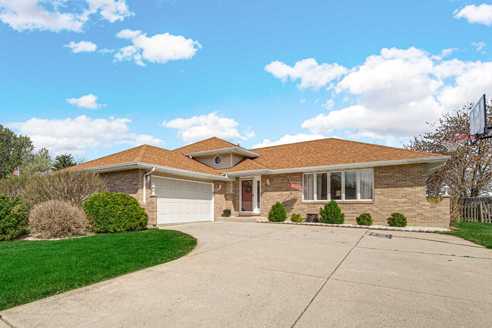 a front view of a house with a garden and a yard