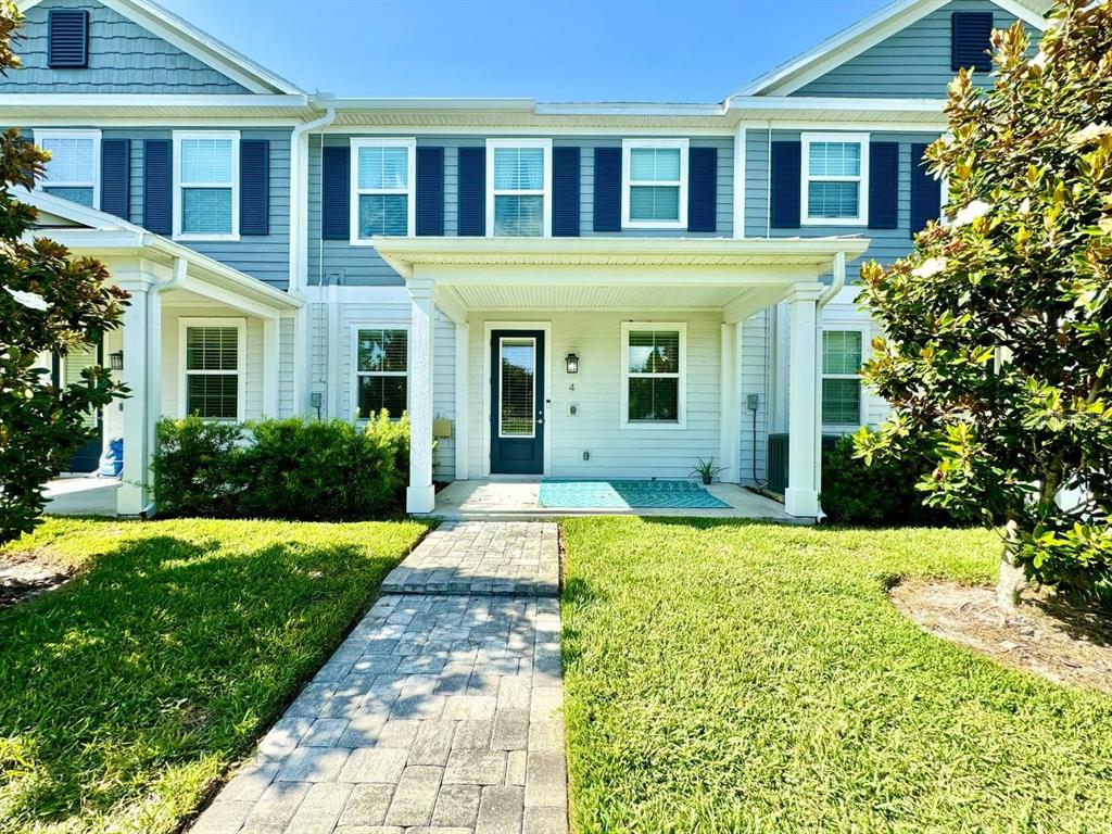 a front view of a house with yard and green space