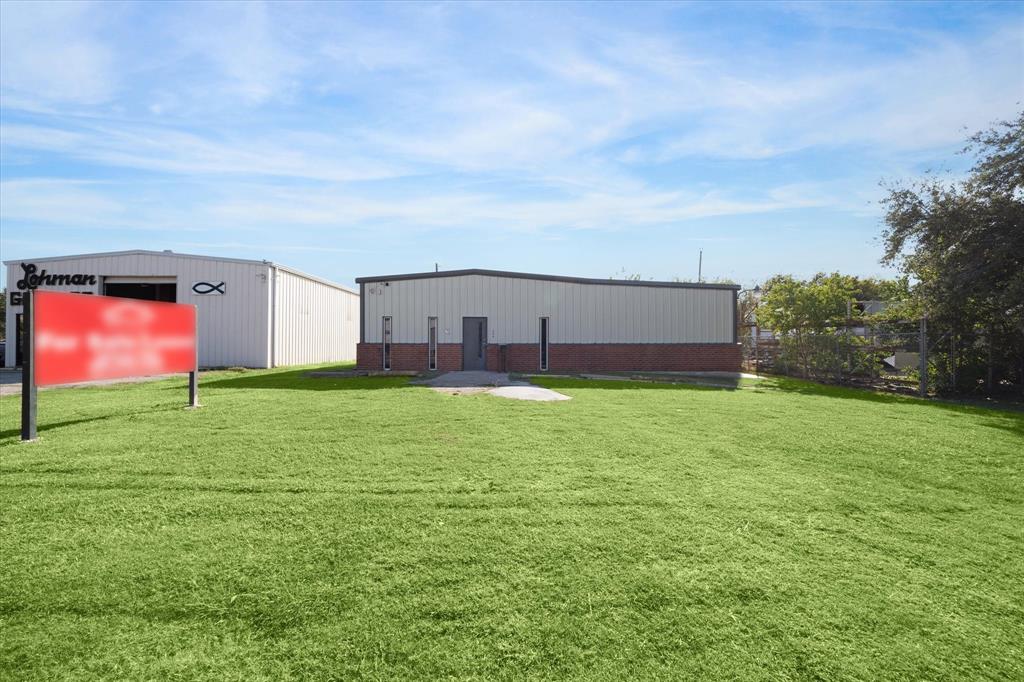 a view of a big room with a big yard and large trees