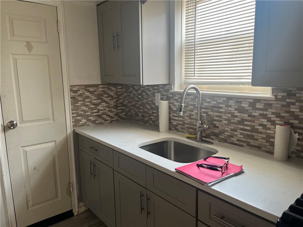 a kitchen with a sink and cabinets