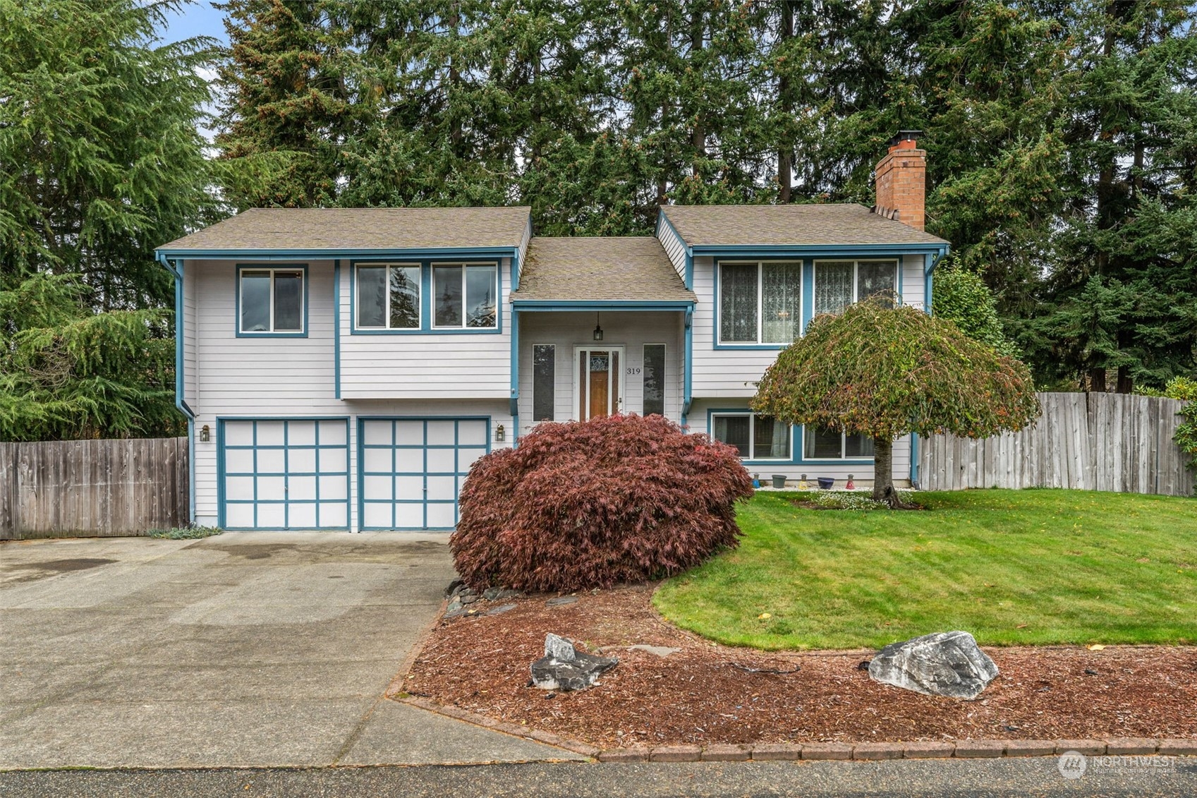 a front view of a house with a garden