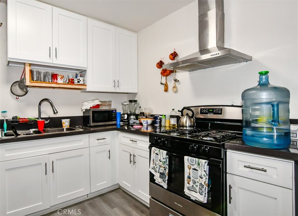 a kitchen with stainless steel appliances granite countertop a sink and cabinets