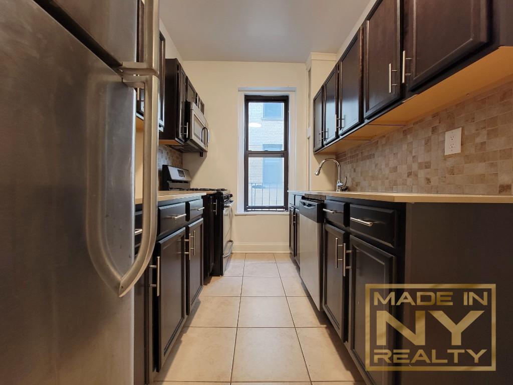 a kitchen with stainless steel appliances granite countertop a stove and a refrigerator