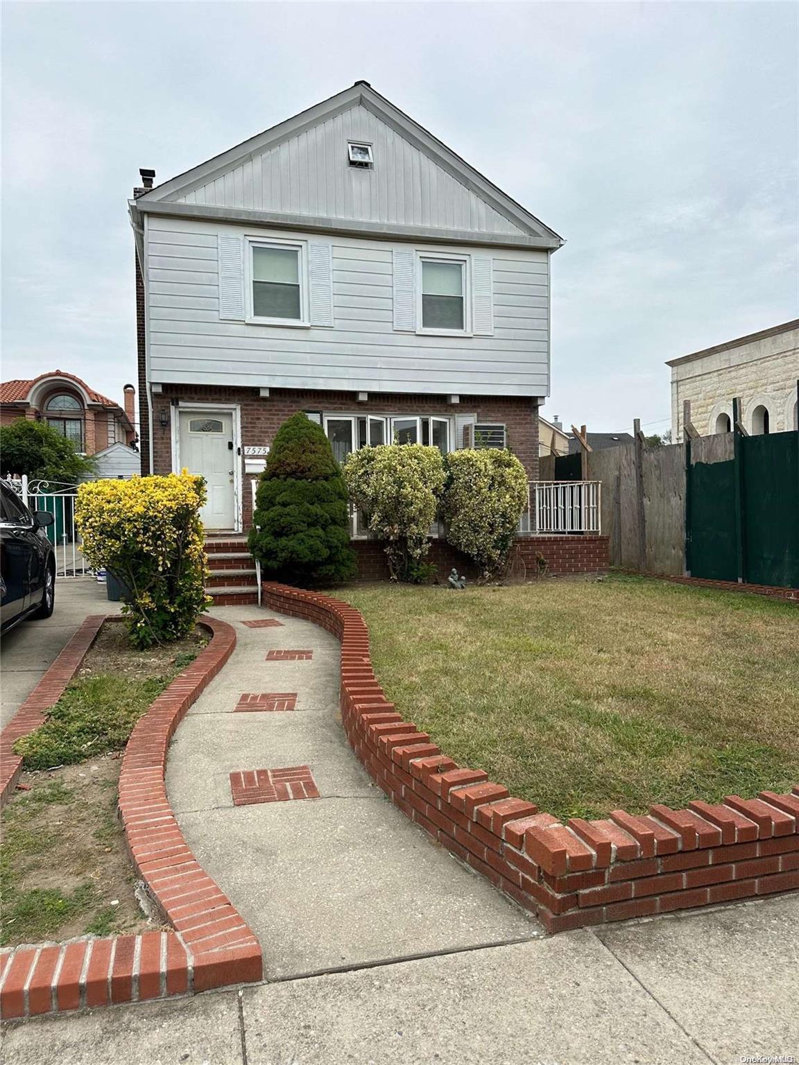 a front view of a house with garden