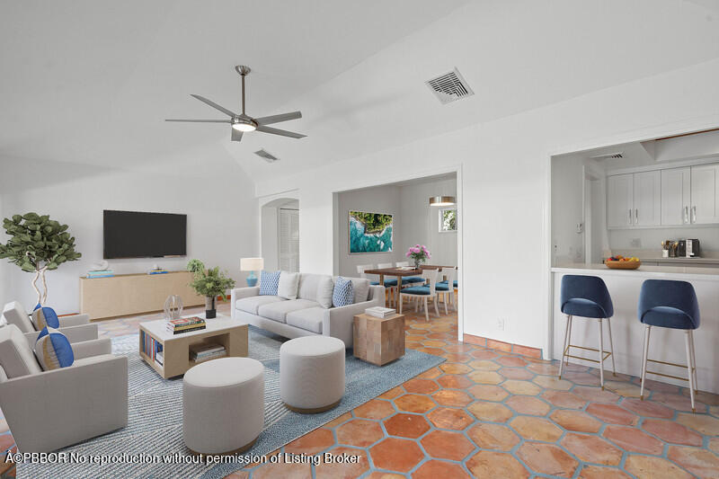 a living room with furniture potted plant and a view of kitchen