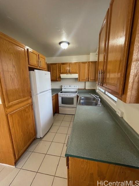 a kitchen with a refrigerator and a sink