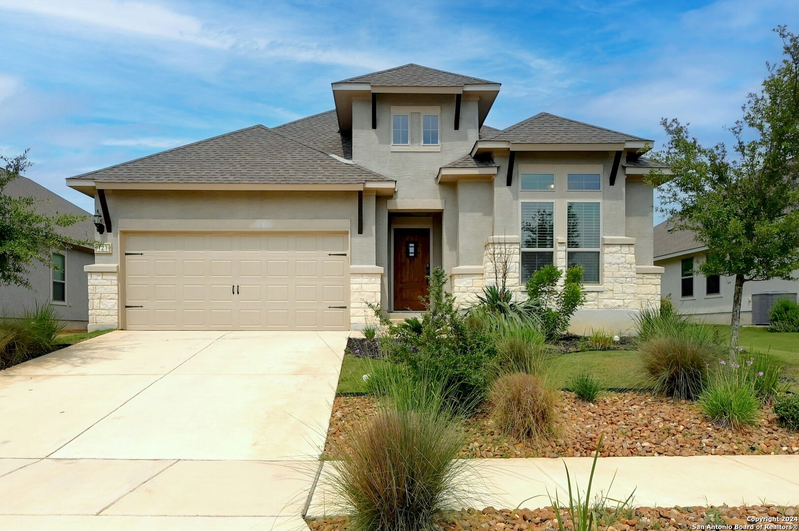 a front view of a house with garden