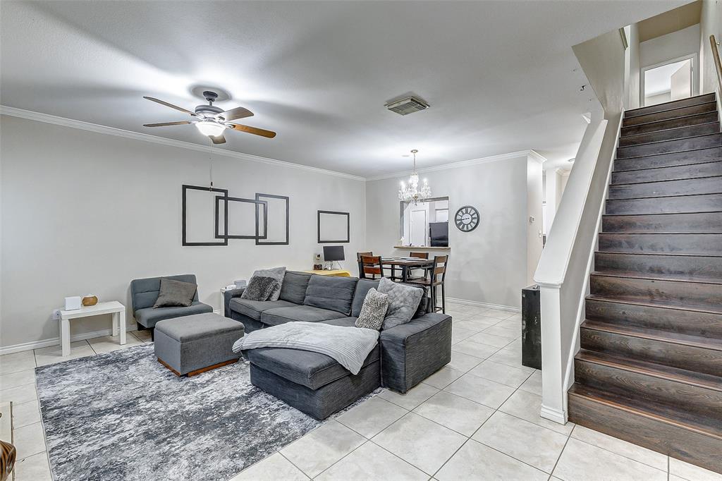 a living room with furniture and a chandelier