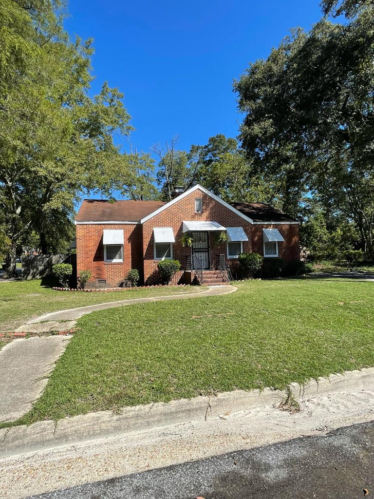 a front view of a house with a garden