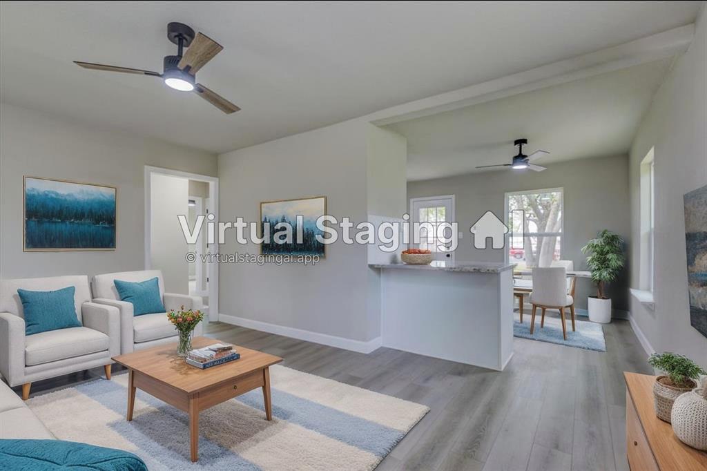 a living room with furniture and view of kitchen