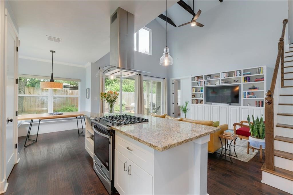 a kitchen with granite countertop sink stove and refrigerator