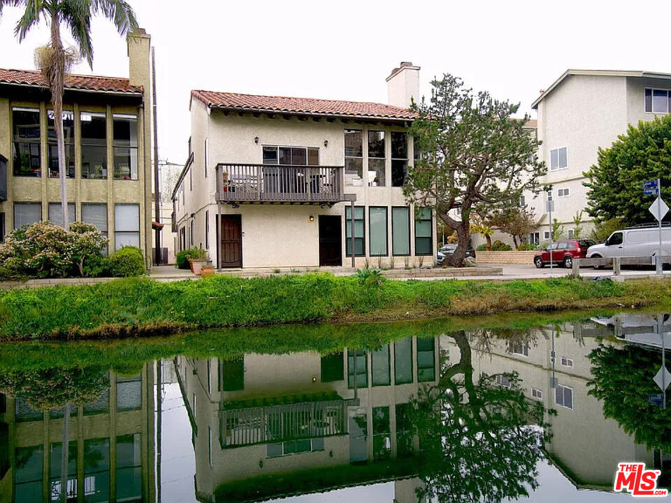 a front view of a house with garden and lake view