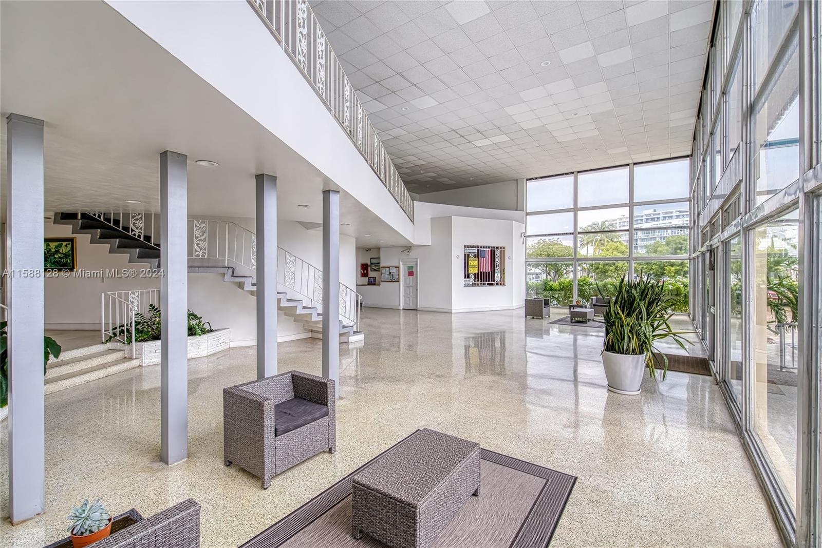 a lobby with furniture and floor to ceiling window