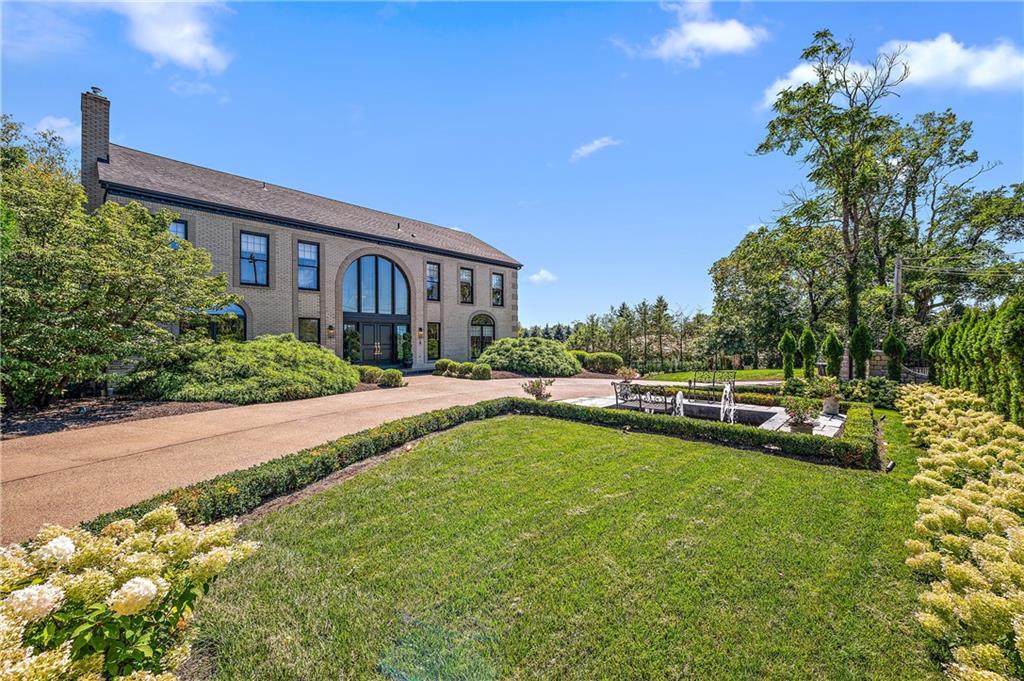 a view of a house with swimming pool next to a yard