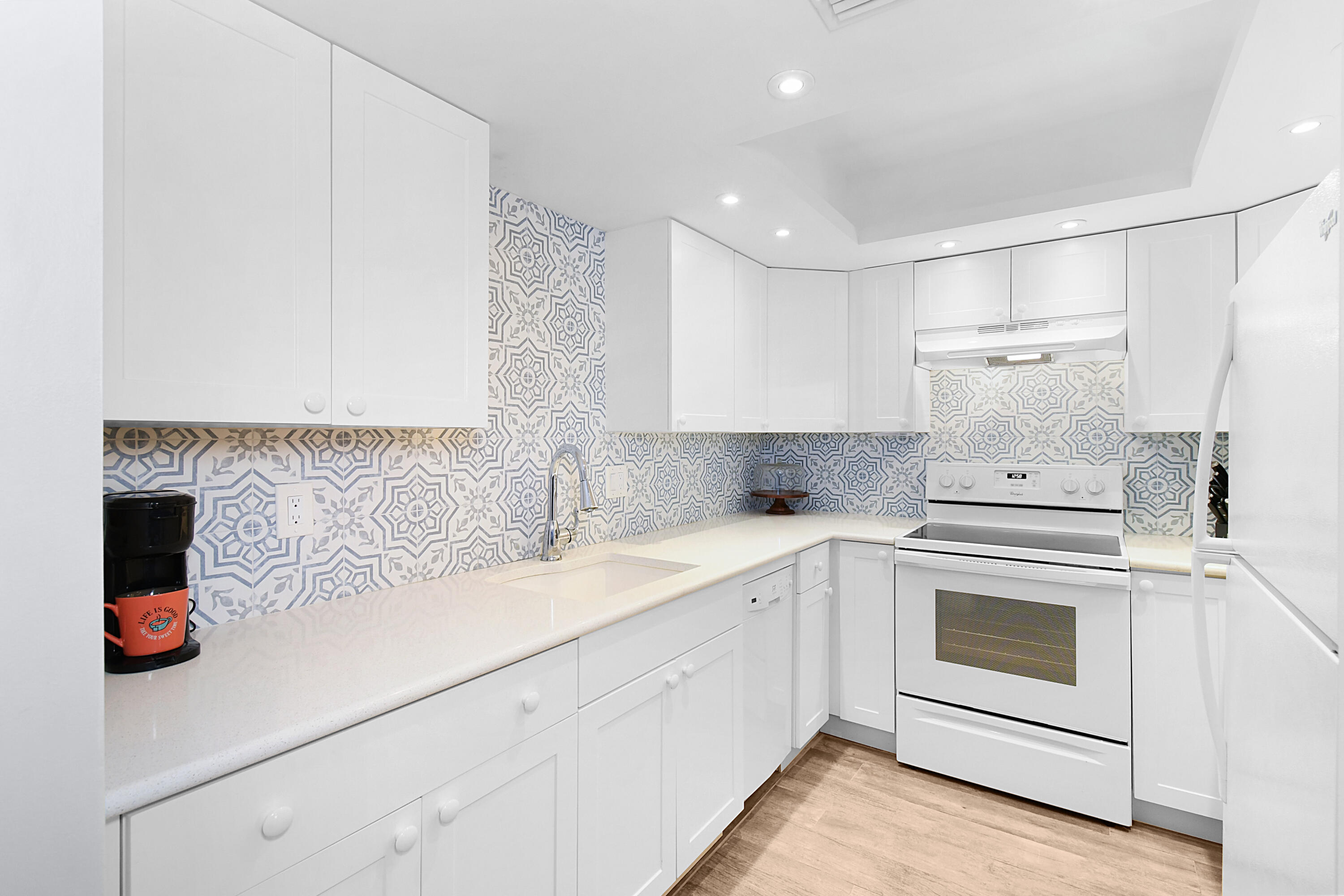 a kitchen with a white cabinets and white appliances