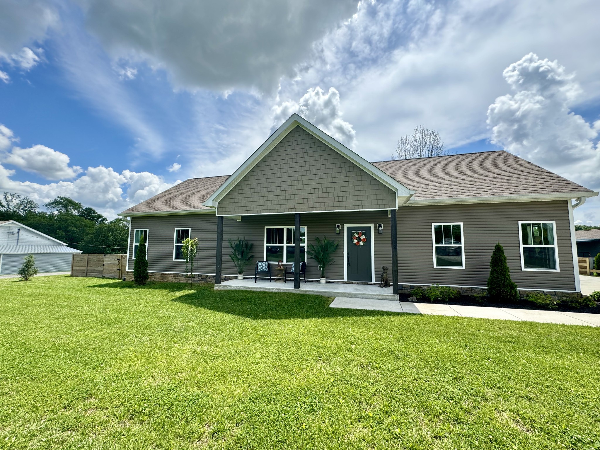 a front view of house with yard and green space