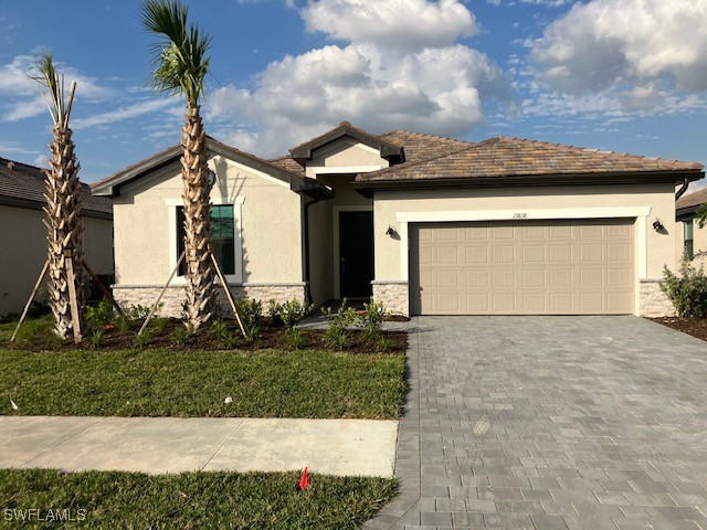 a front view of a house with a yard and garage