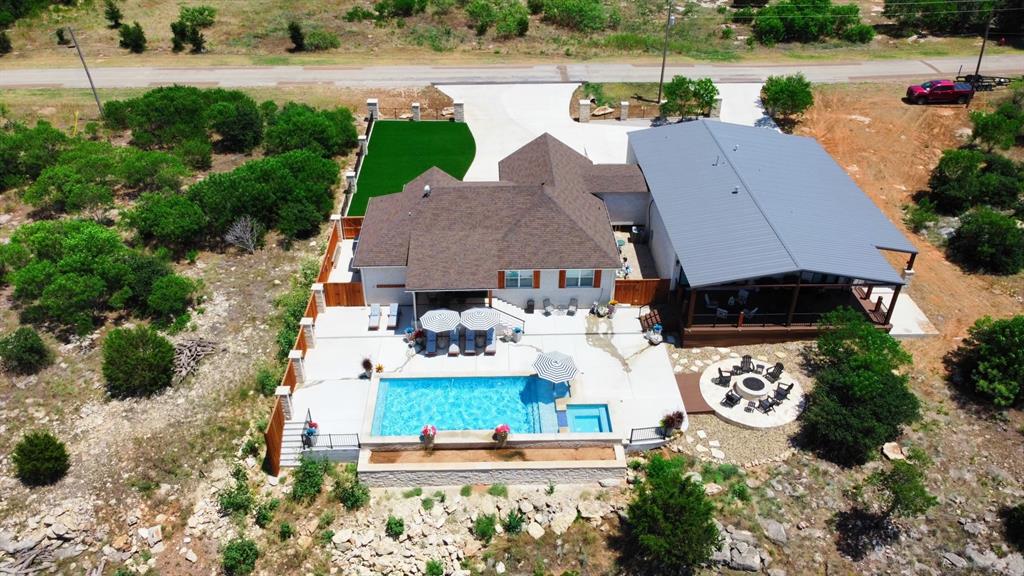 an aerial view of a house with outdoor space and lake view