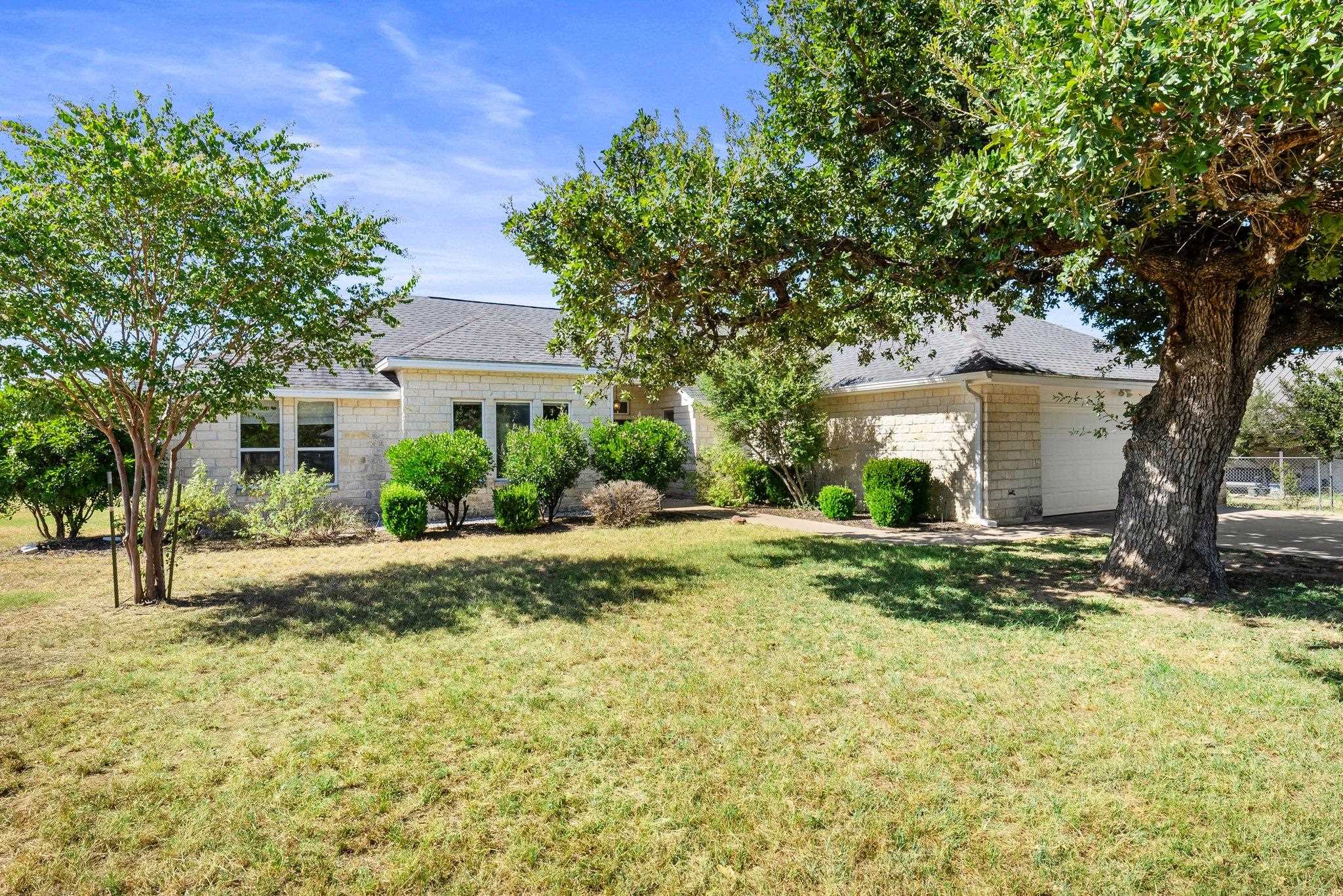 a view of a house with a tree in the background