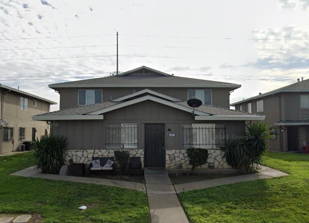 a front view of a house with garden