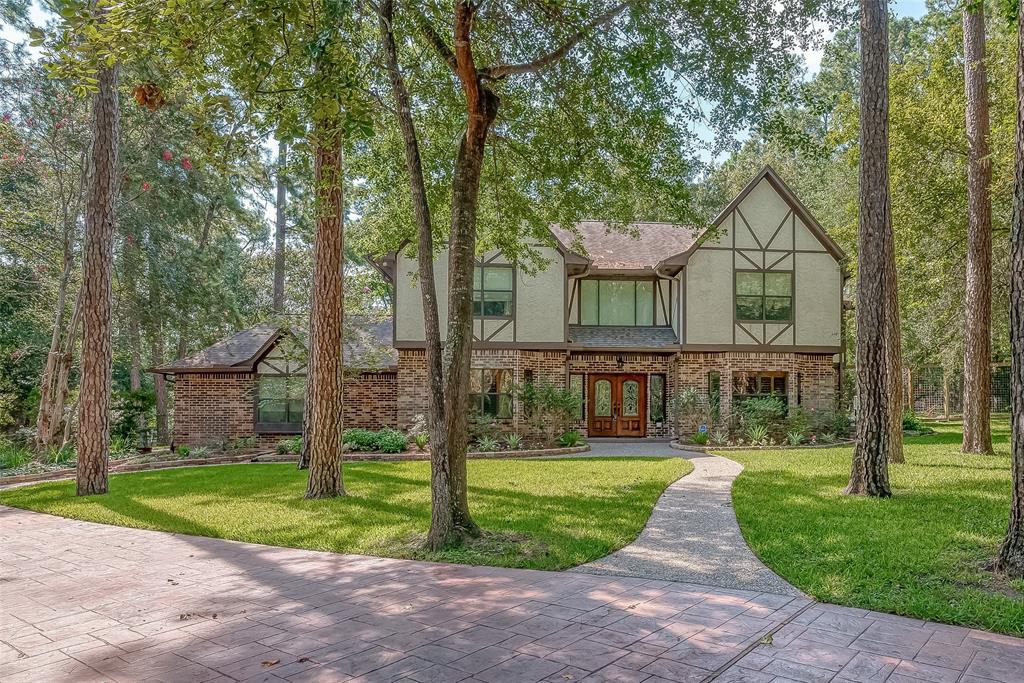 a front view of house with yard and green space