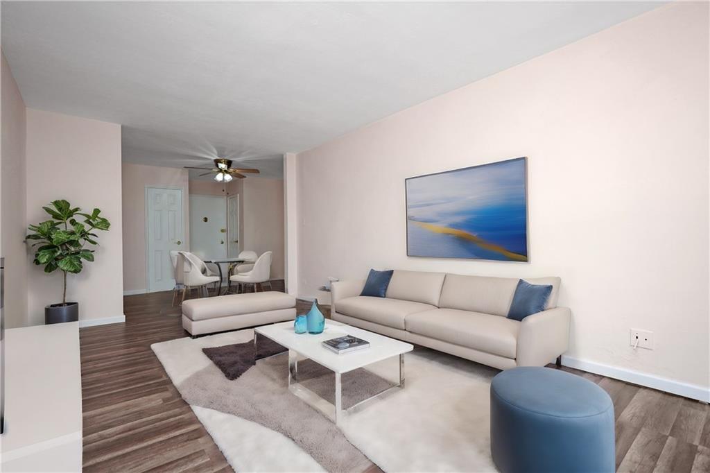 a living room with furniture and a potted plant