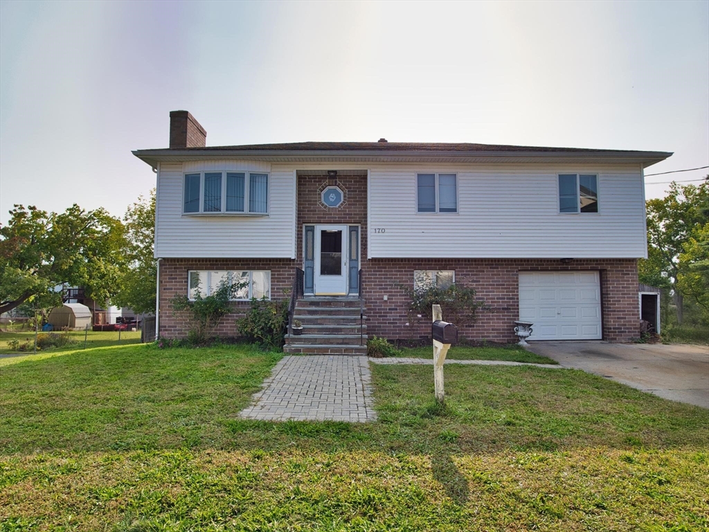 a front view of a house with a yard and garage