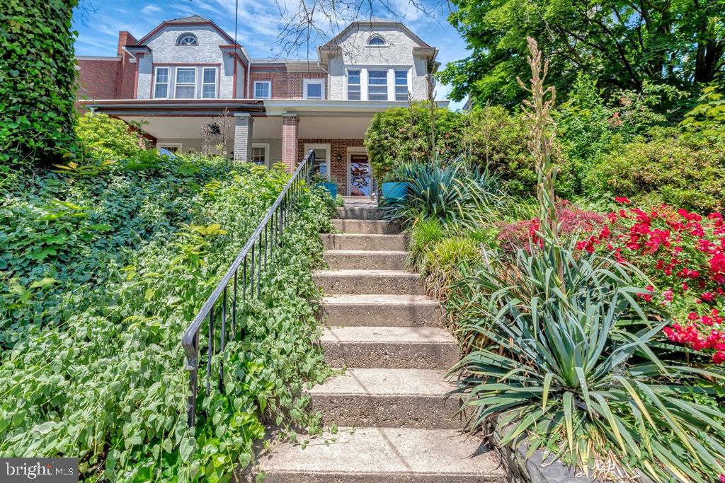 a front view of a house with a garden