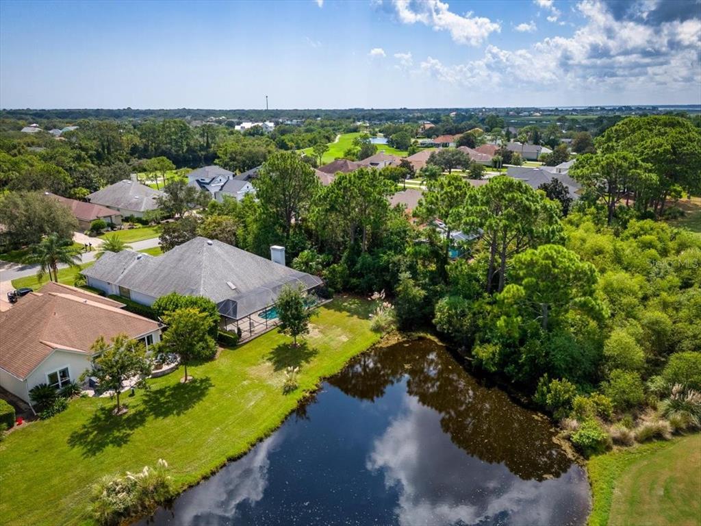 an aerial view of a houses with a yard